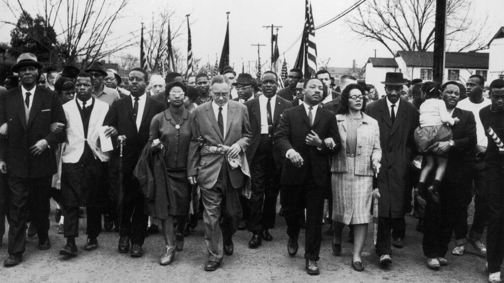 An old photo of Martin Luther King marching with a group