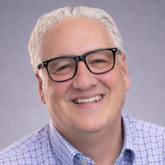 Close up headshot of John Arms smiling